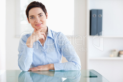 Smiling Businesswoman sitting behind a desk