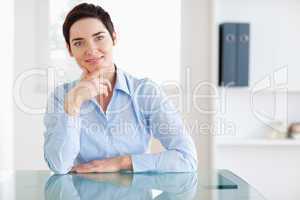 Smiling Businesswoman sitting behind a desk