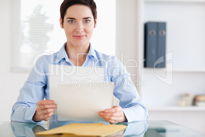 Portrait of a brunette Businesswoman sitting behind a desk with