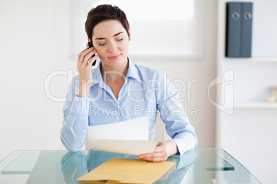 Portrait of a brunette Businesswoman sitting behind a desk with