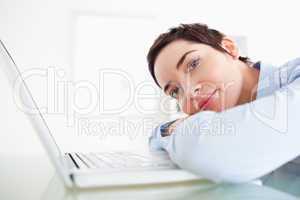 Smiling short-haired businesswoman with a laptop
