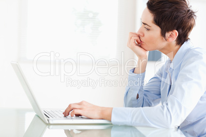 Bored short-haired businesswoman with a laptop