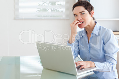 Upset brunette Businesswoman with a laptop