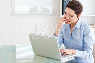 Angry brunette Businesswoman with a laptop
