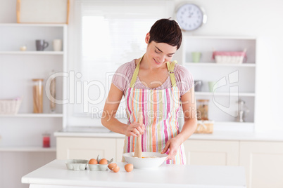 Brunette woman preparing a cake