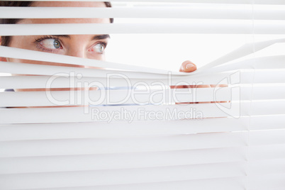 Woman peeking out of a window