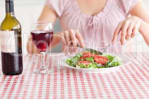 Cute Woman eating lunch and drinking wine
