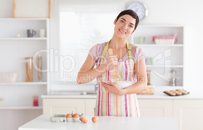 Charming brunette woman preparing a cake