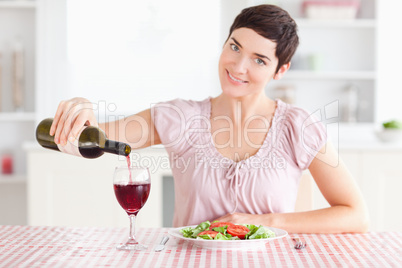 Woman pouring redwine in a glass