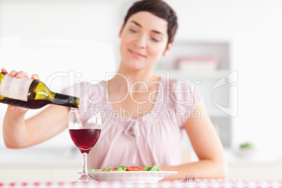 Charming Woman pouring redwine in a glass