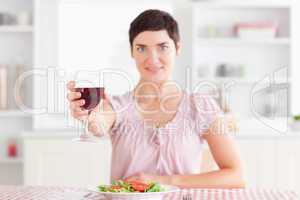 Smiling Woman toasting with wine