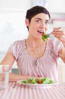 Joyful Woman eating salad