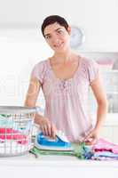 Smiling Woman ironing clothes