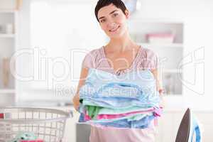 Brunette Woman with a pile of clothes