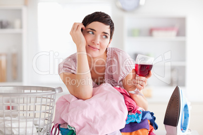 Woman with wine and a pile of clothes