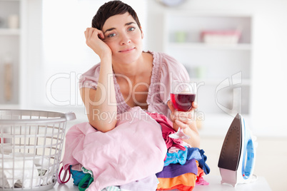 Sad Woman with wine and a pile of clothes