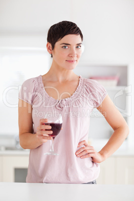 Woman with a glass of wine looking into the camera