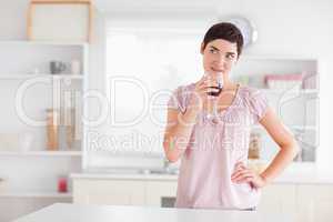 Thoughtful woman drinking wine