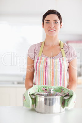 Smiling woman holding a pot