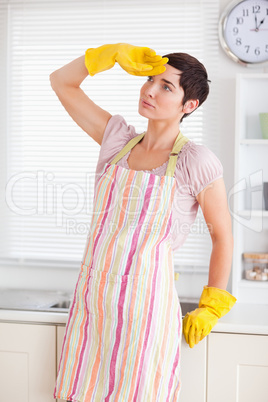 Tired woman in cleaning gown