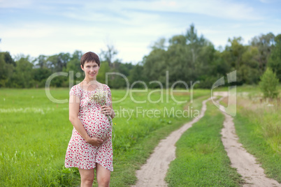 Pregnant woman with chamomile bouquet