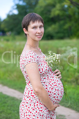 Pregnant woman with chamomile bouquet