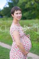 Pregnant woman with chamomile bouquet