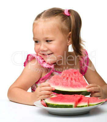 Cute little girl is going to eat watermelon