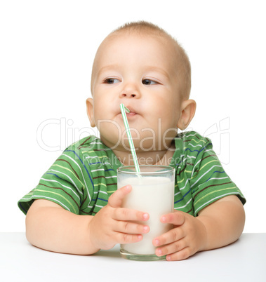 Cute little boy is drinking milk