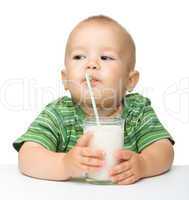 Cute little boy is drinking milk