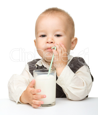 Cute little boy is drinking milk