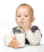 Cute little boy is drinking milk