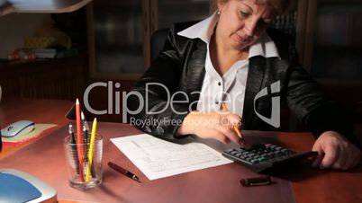business woman fills out a 1040 tax form. slider shot.