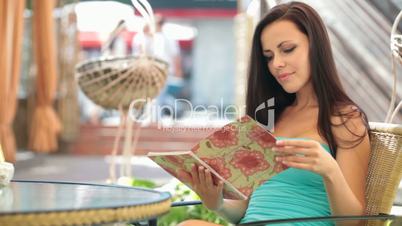 woman reading menu in restaurant