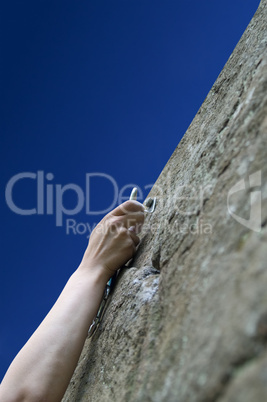Climber's hand with quick-draws