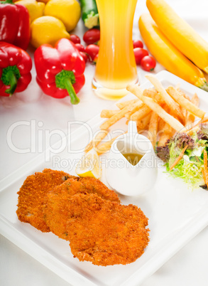 classic Milanese veal cutlets and vegetables