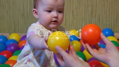 baby playing with plastic balls