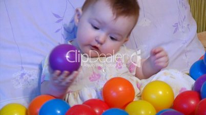 baby playing with plastic balls
