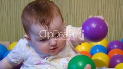 baby playing with plastic balls