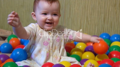 baby playing with plastic balls