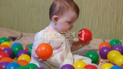 baby playing with plastic balls