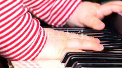 baby playing with piano