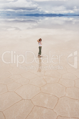 young woman staring, salar de uyuni salt lake, bolivia