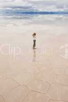 young woman staring, salar de uyuni salt lake, bolivia