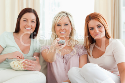 Charming Women watching a movie eating popcorn