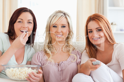 Smiling Friends lounging on a sofa watching a movie