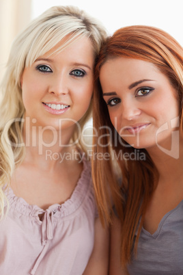 Smiling women lounging on a sofa