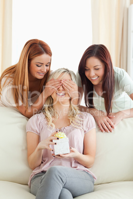 Young women giving their friend a present