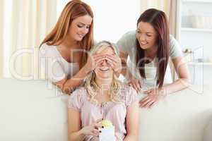 Cute women giving their friend a present