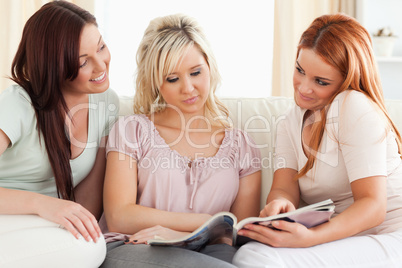 Smiling Women reading a magazine